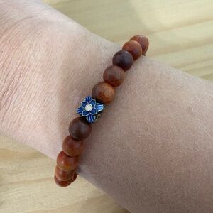 Brown Beaded Bracelet with Blue Flower Charm